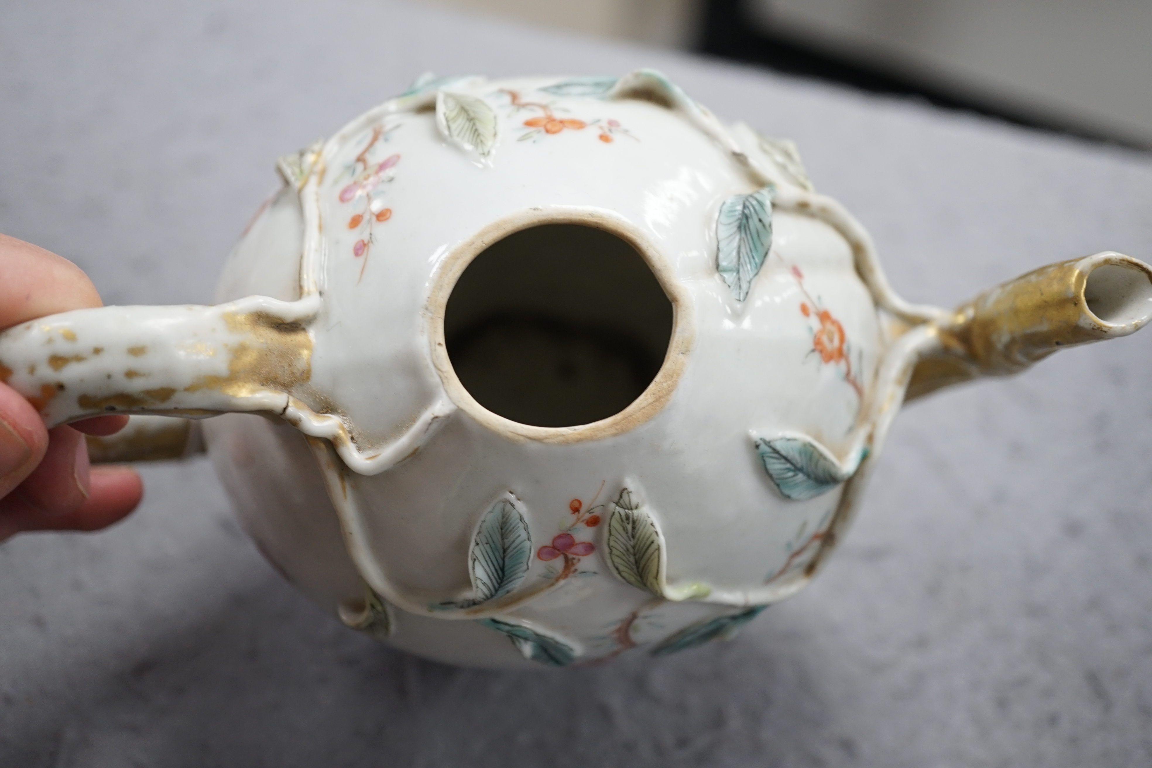 A Chinese enamelled porcelain peach-shaped teapot, Qianlong period (1736-95), wear to gilding